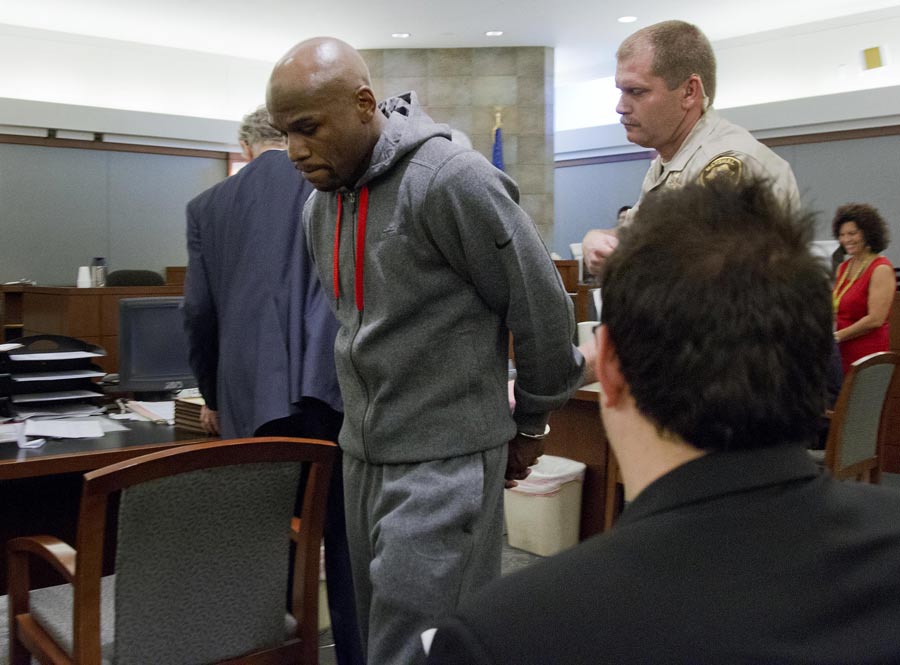 Floyd Mayweather Jr is led away by court marshall Ron Johnson