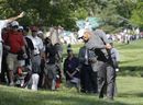 Tiger Woods hits out of the rough on the 15th hole 