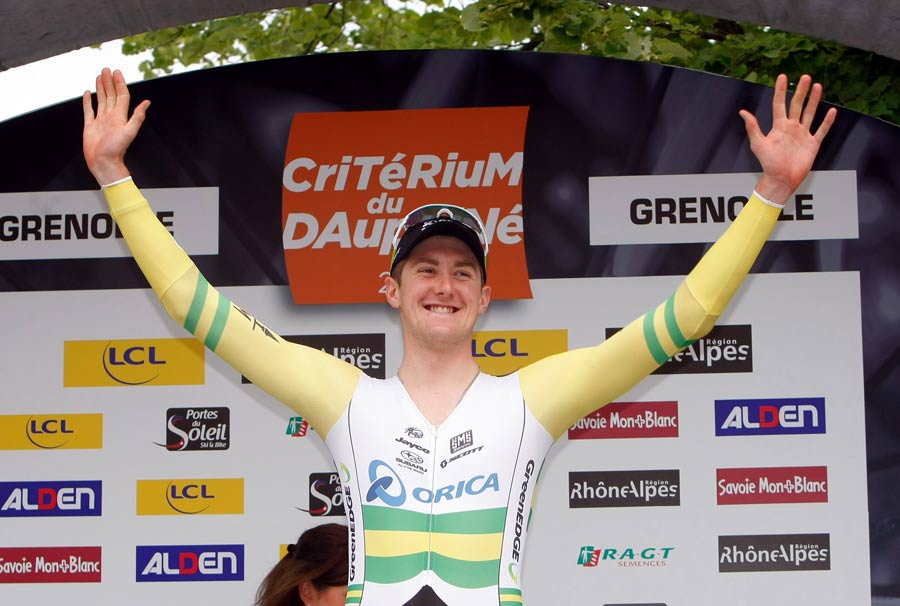 Luke Durbridge celebrates on the podium after winning the prologue 