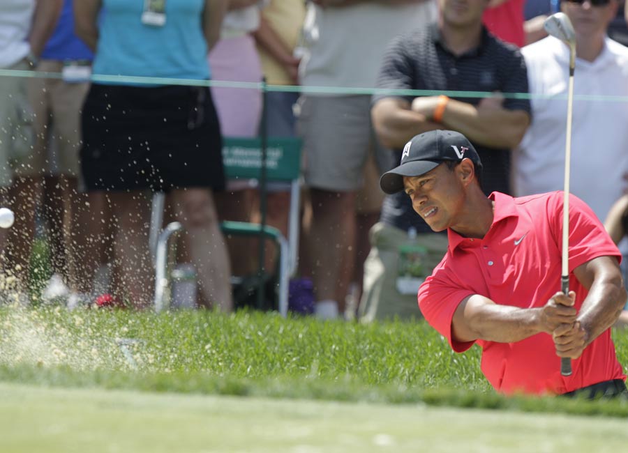 Tiger Woods plays from a bunker