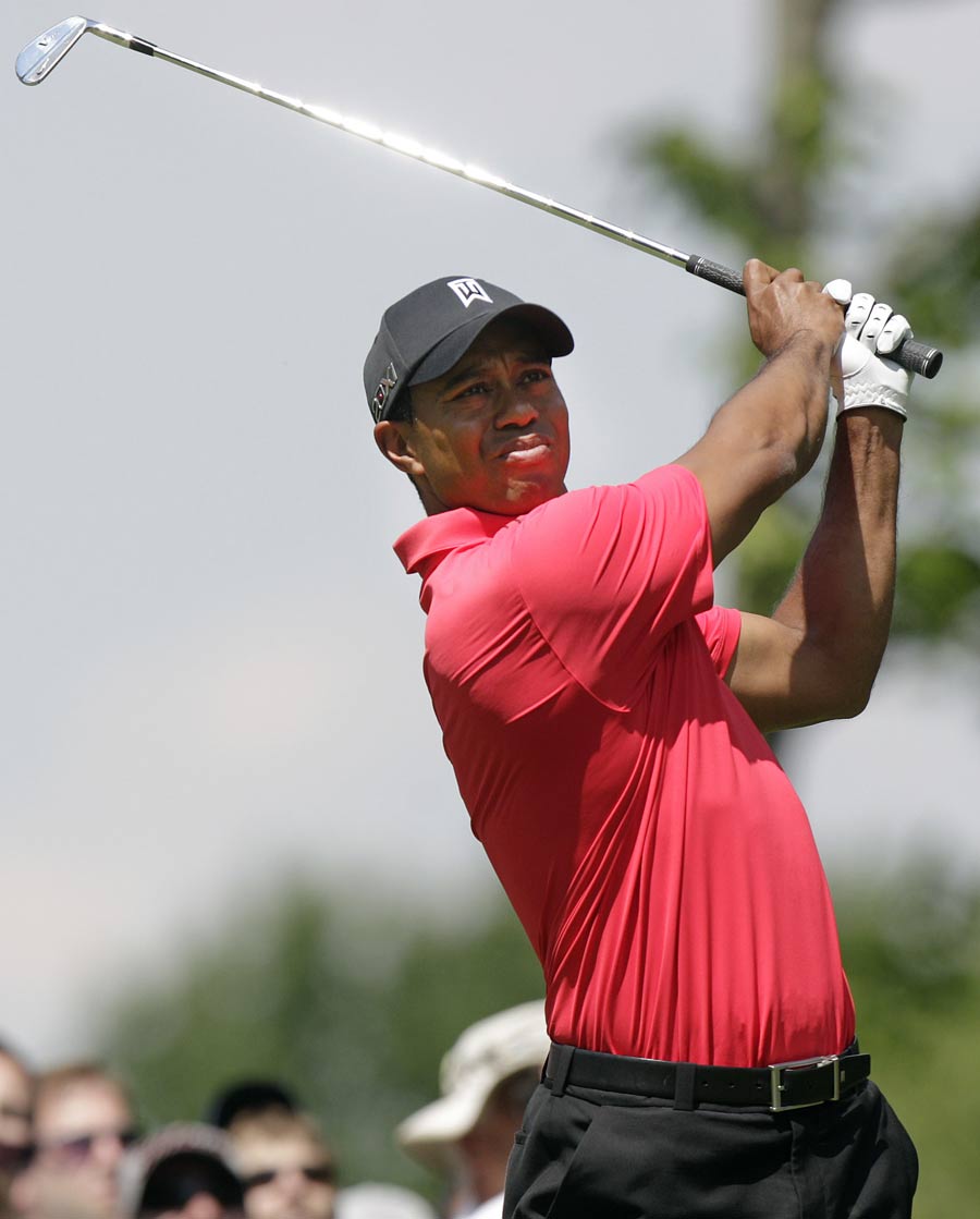 Tiger Woods follows his iron