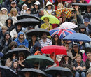 Fans wait for the rain to clear