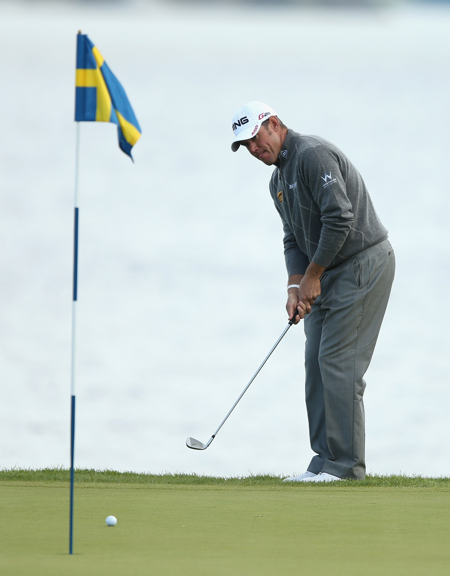 Lee Westwood chips onto the green