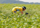 Bradley Wiggins rides through a field