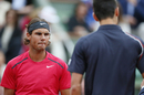 Rafael Nadal and Novak Djokovic meet at the net