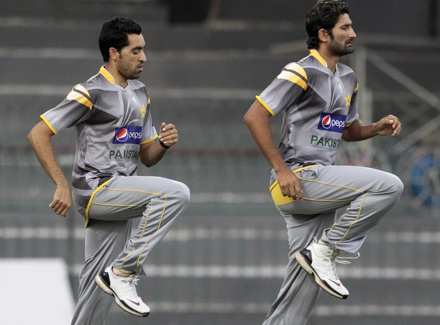 Umar Gul and Sohail Tanvir hop during a practice session