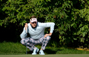 Ian Poulter lines up a putt