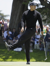 Tiger Woods swings his foot after missing a putt