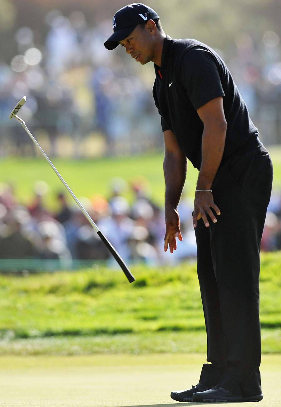 Tiger Woods throws his putter in disgust