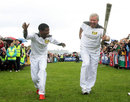 Haile Gebrselassie and Brendan Fraser carry the Olympic torch