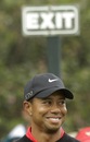Tiger Woods beneath an appropriate sign