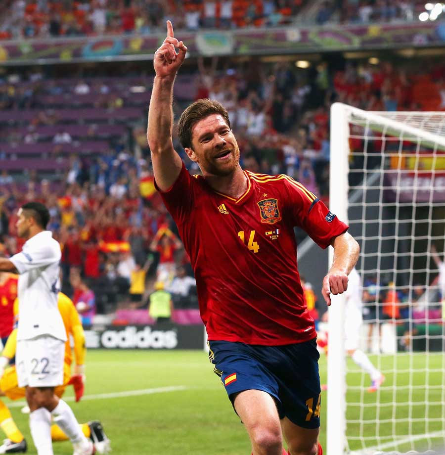 Xabi Alonso wheels away in delight after his opener