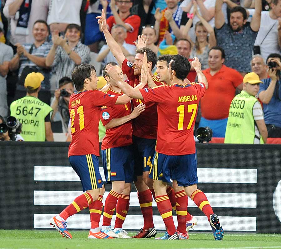 Spain players celebrate Xabi Alonso's goal