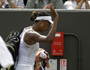 Venus Williams waves as she leaves the court
