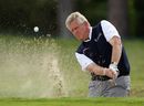 Colin Montgomerie plays a bunker shot on the 18th hole