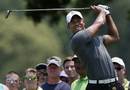Tiger Woods follows his tee shot