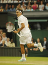 Roger Federer celebrates winning the fourth set