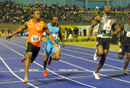 Yohan Blake celebrates after crossing the  line ahead of Usain Bolt 