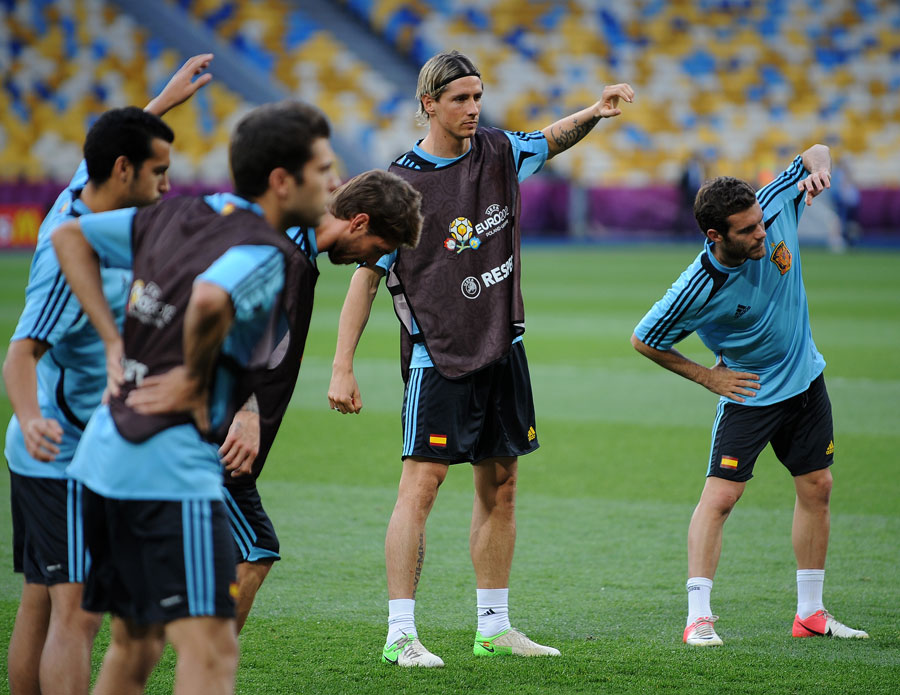 Fernando Torres and Juan Mata stretch during a training session