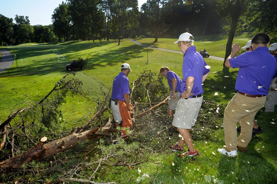 Volunteers clear away fallen tree branches