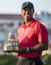 Tiger Woods poses with the trophy
