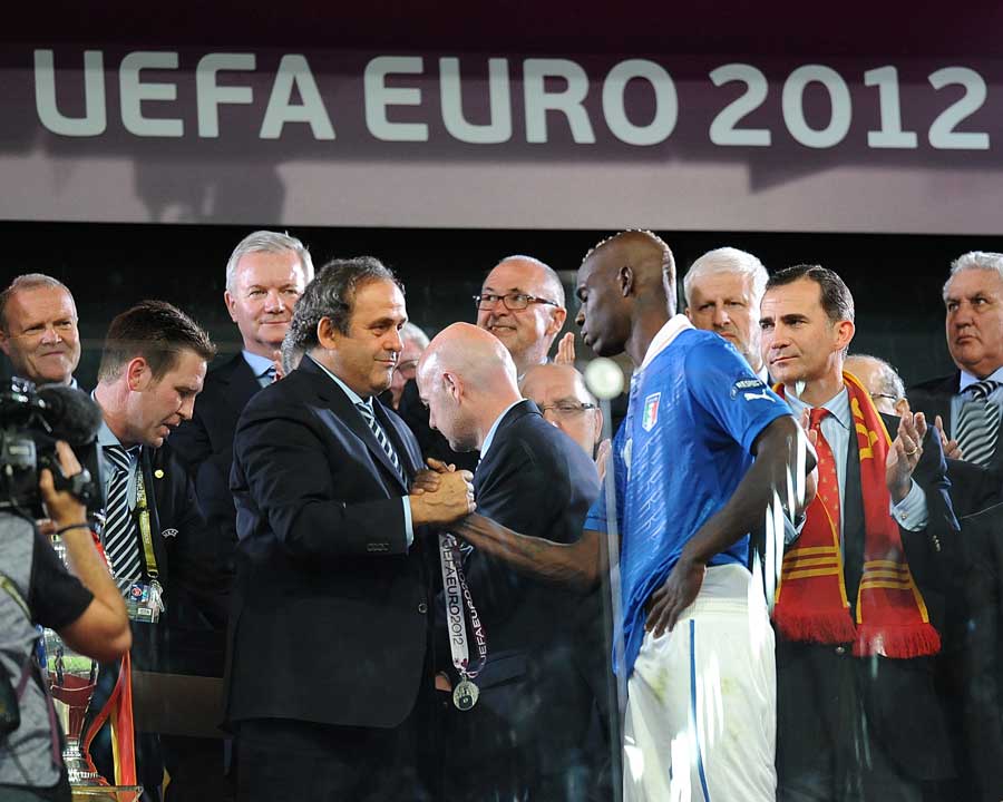 A dejected Mario Balotelli collects his runners-up medal 