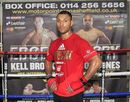 Kell Brook poses in front of a promotional poster