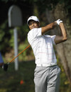 Tiger Woods follows his drive during the ProAm