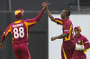 Andre Russell celebrates with this captain Darren Sammy