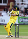 The ball disturbs the bails on its way down after hitting David Hussey on the helmet
