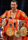 Wladimir Klitschko shows off his belts after beating Tony Thompson