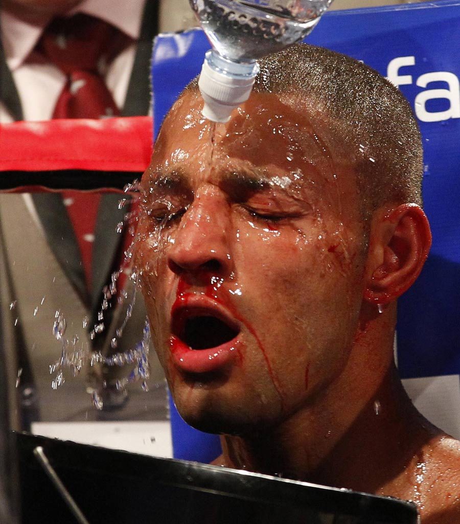 Kell Brook is showered with water in his corner
