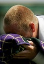Martin Lee buries his head in his towel at Wimbledon