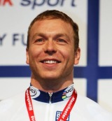 Chris Hoy stands on the podium after winning the Men's Sprint 
