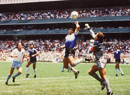Diego Maradona handles the ball past Peter Shilton
