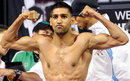 Amir Khan poses during his weigh-in