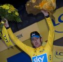 Bradley Wiggins celebrates on the podium after retaining the yellow jersey