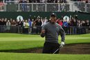 Tiger Woods celebrates after holing at 18