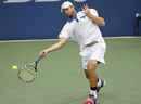 Andy Roddick returns a shot against Michael Russell
