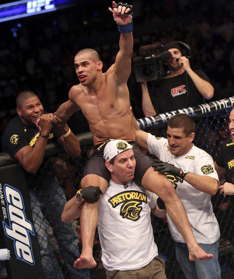 Renan Barao celebrates with his team after victory over Urijah Faber