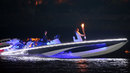 David Beckham drives the speedboat carrying the Olympic flame