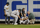 Josh Reddick is tended to after crashing into the wall