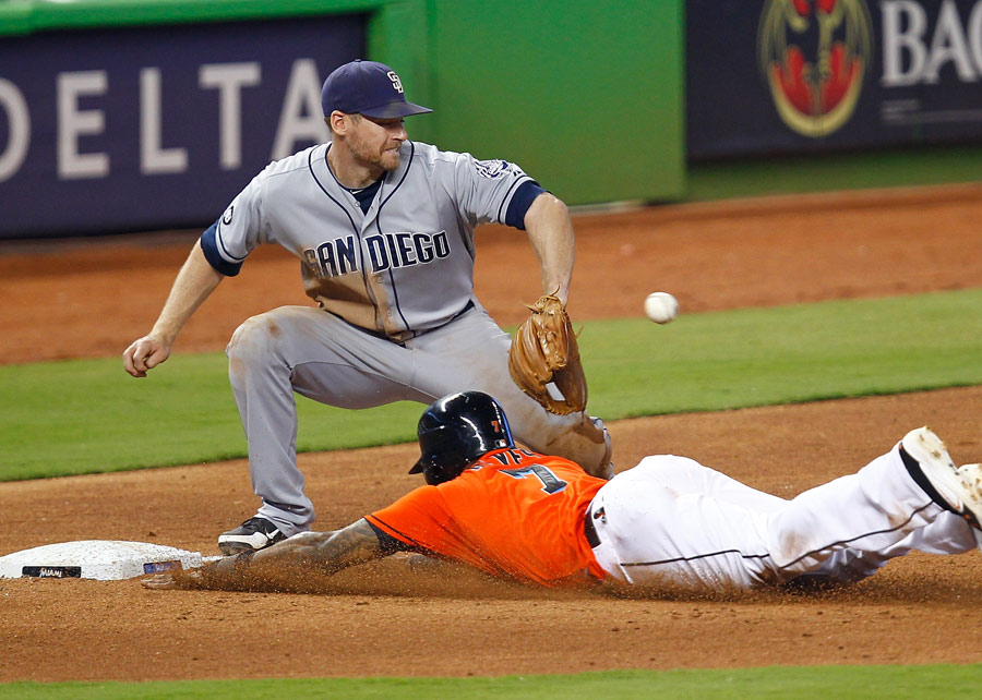 Jose Reyes of the Miami Marlins slides safely into third base