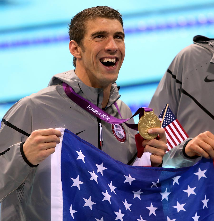 Michael Phelps celebrates with his gold medal