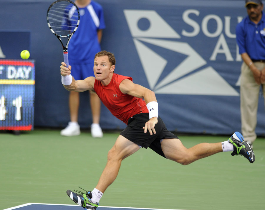Michael Russell dashes across the court for a forehand