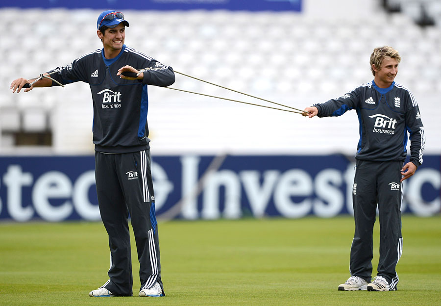 James Taylor helps out Alastair Cook during training