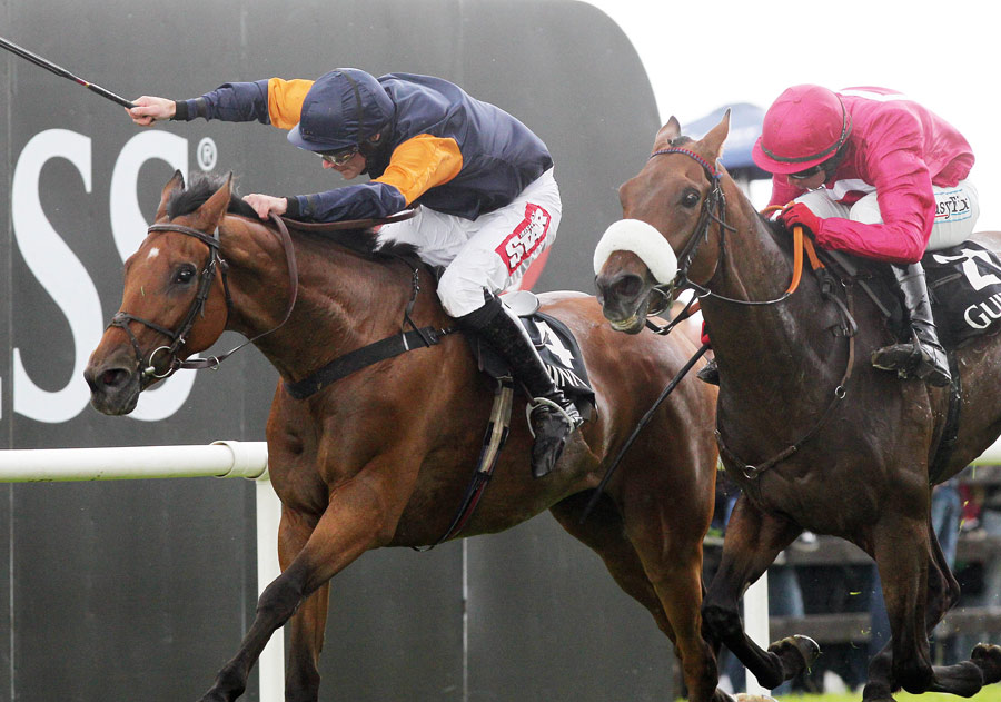 Rebel Fitz ridden by Davy Russell holds on Cause Of Causes and Davy Condon in the Galway Hurdle