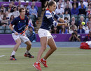 Laura Robson hits a volley as partner Andy Murray watches on