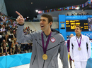 Michael Phelps points to his family after his latest gold medal