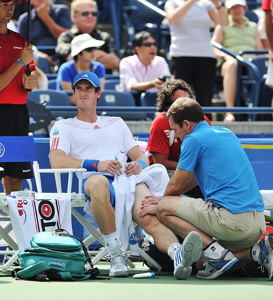 Andy Murray receives treatment on his knee
